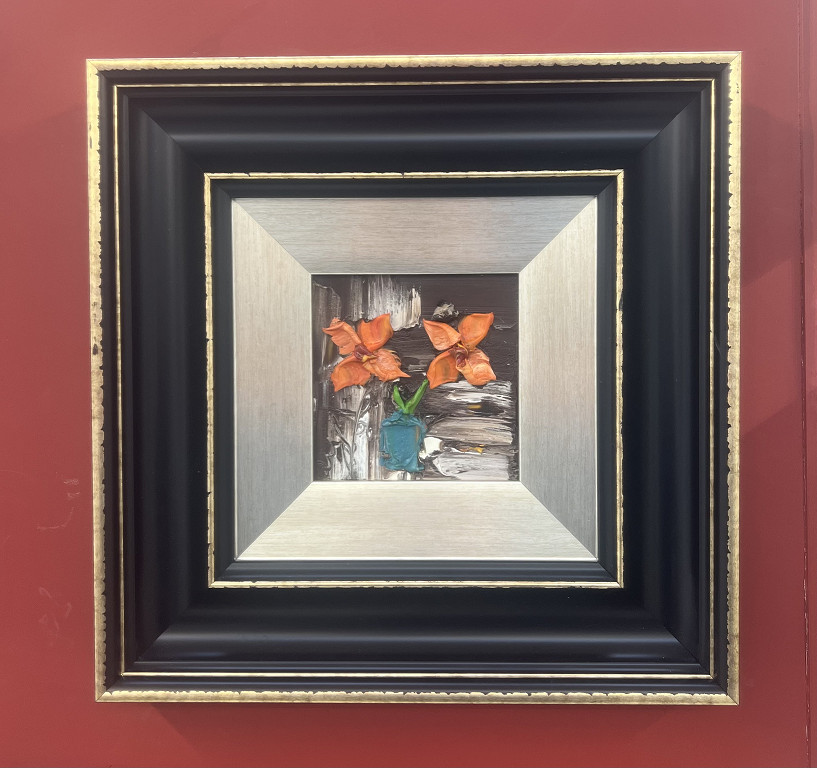 Orange flowers in teal vase